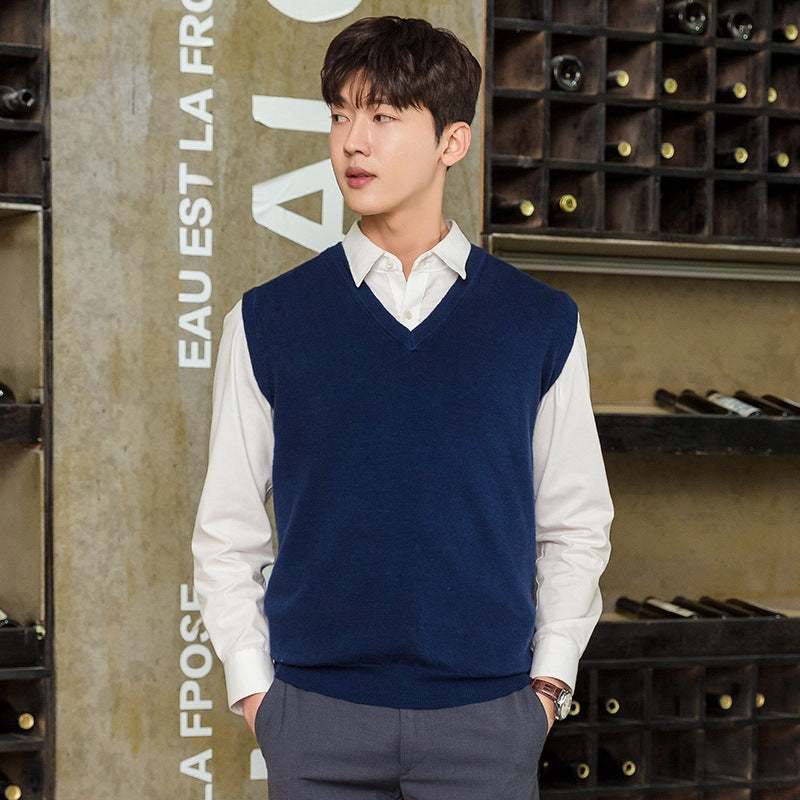 Man wearing navy blue mens vest pullover over white shirt in casual indoor setting