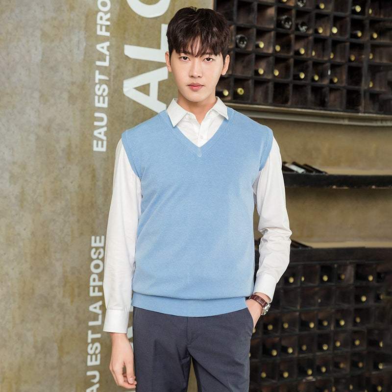 Man wearing light blue Mens Vest Pullover over white shirt with dark pants, casual autumn winter style