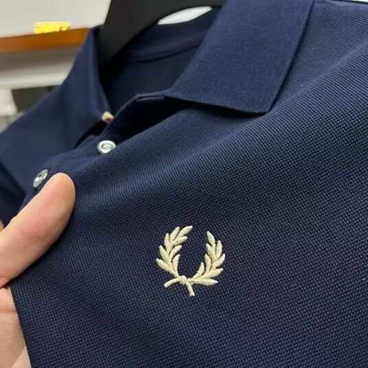 Men's navy lapel half sleeve polo shirt with embroidered logo and button placket