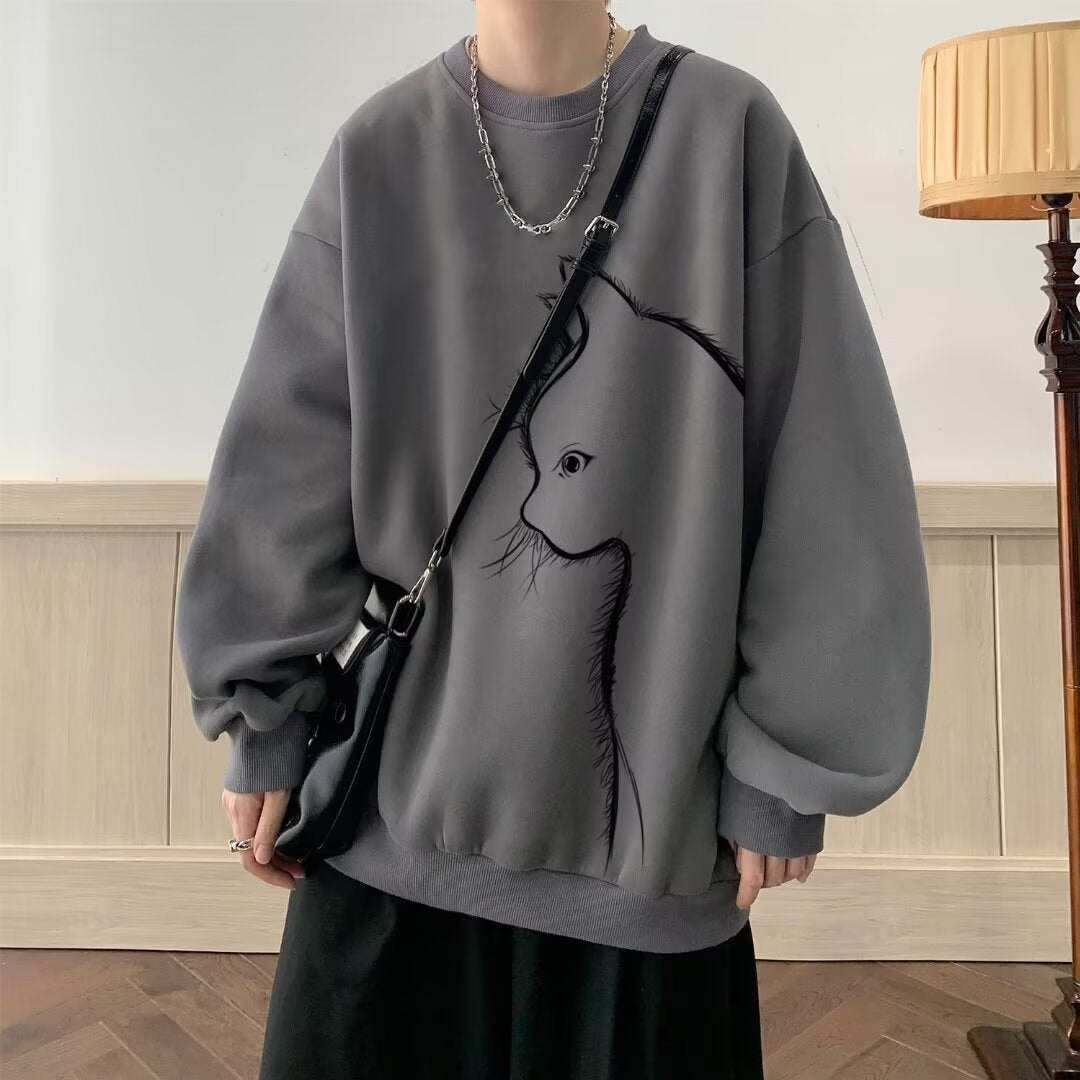 Grey long sleeve sweater with round neck and cat graphic, styled with black pants and accessories