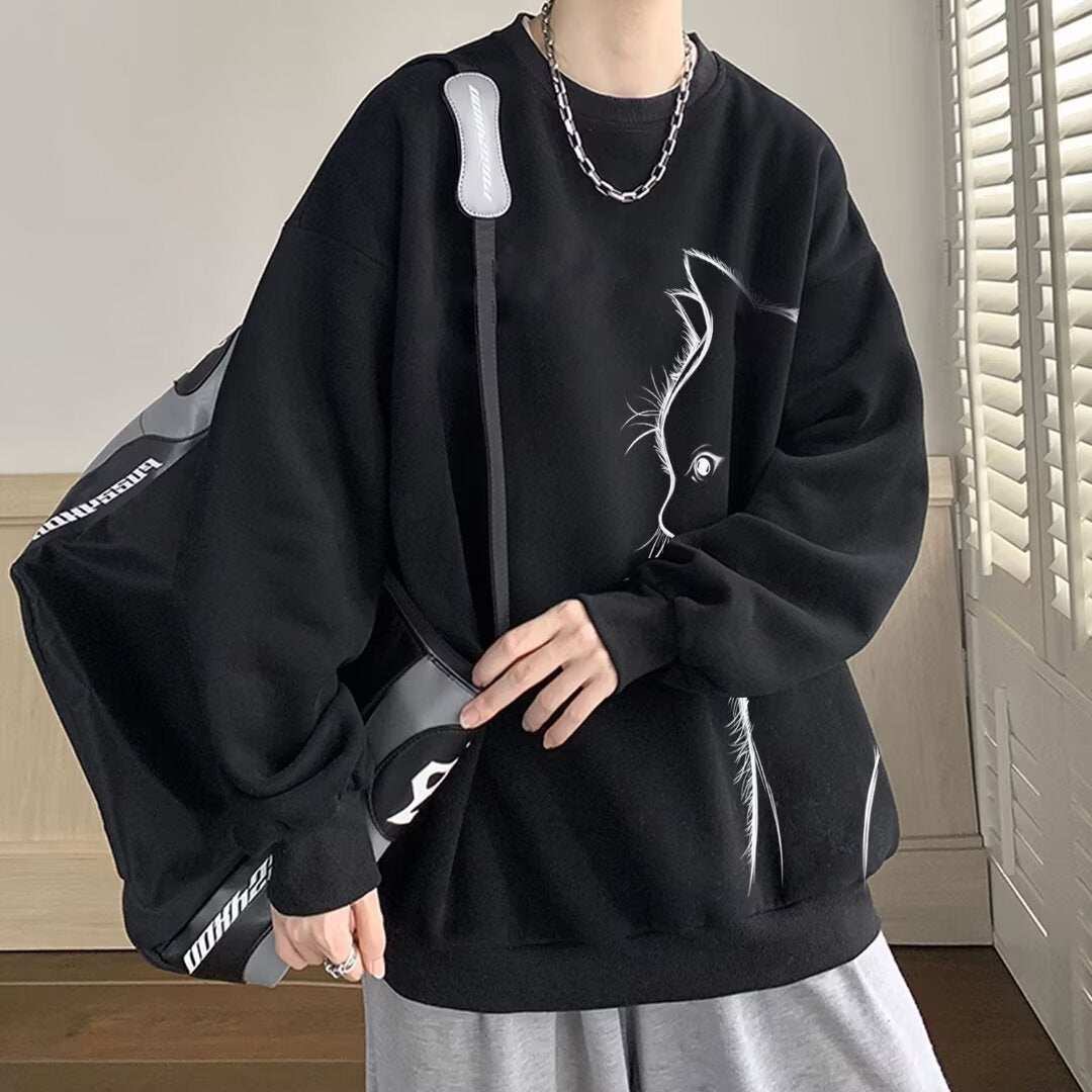Black long sleeve sweater with round neck and cat graphic design worn with silver chain necklace