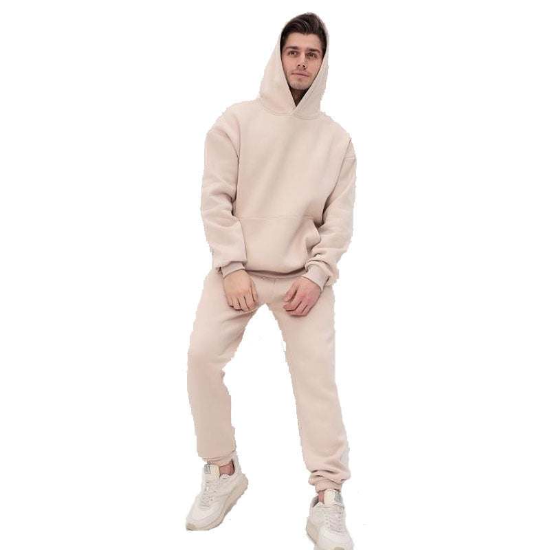 Man wearing beige hoodie two-piece set with matching joggers and sneakers, casual streetwear style