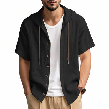 Man wearing black loose hooded short-sleeved linen shirt with button front and white undershirt