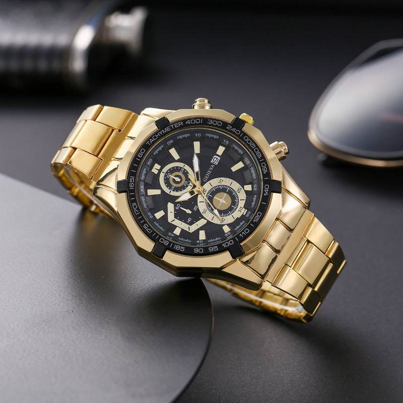 Gold quartz watch with black dial, tachymeter, and stainless steel band on dark surface.